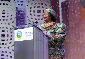 Joyce Banda behind the Summit Podium, giving a speech. 