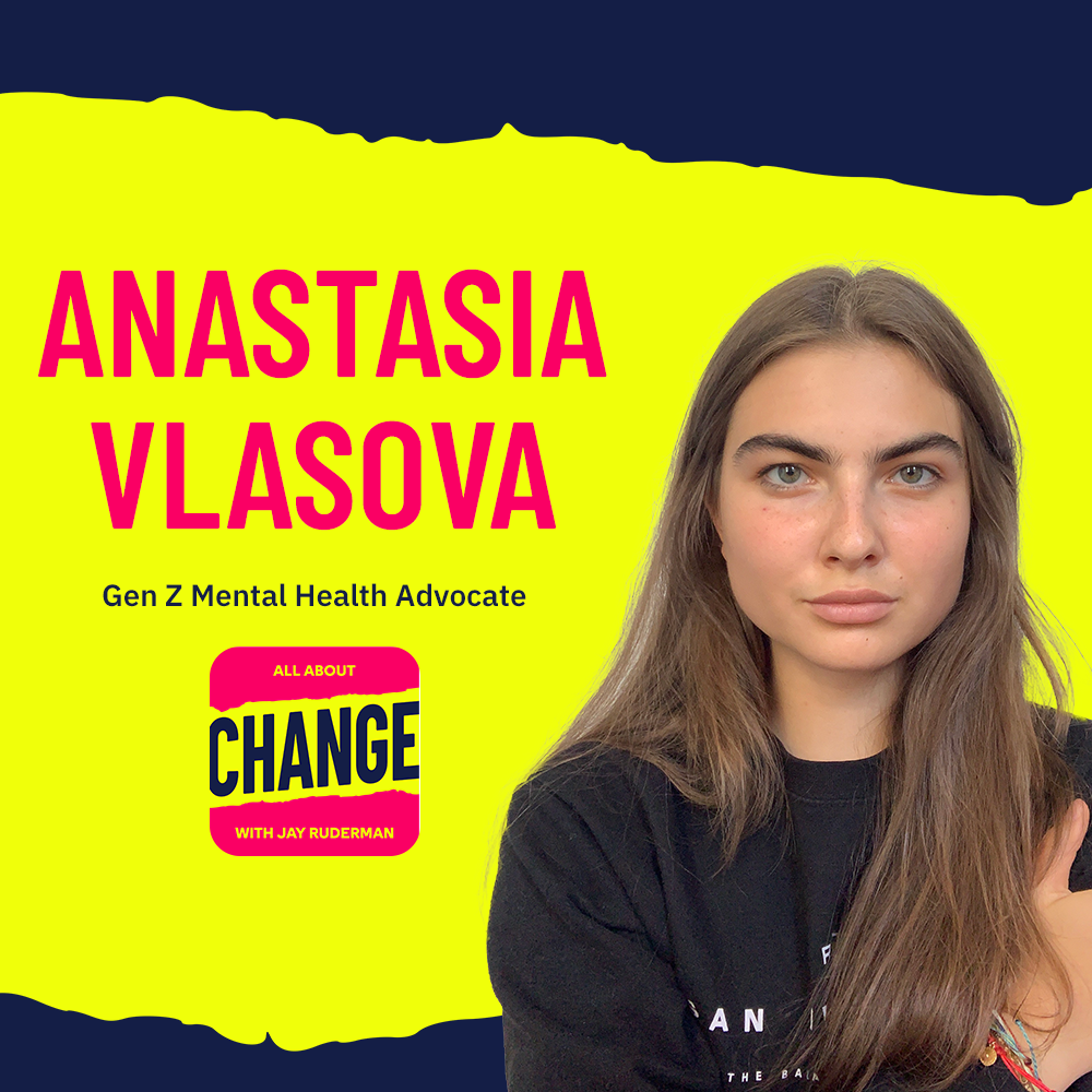 Square graphic with blue and yellow background. The blue is on the top and bottom and the yellow is sandwiched in between. On the right side is a photo of Anastasia Vlasova. She has long brown hair and brown eyes. She has a serious look on her face. She is wearing a black sweater and crossing her arms. On the top in red bold letters reads “Anastasia Vlasova”. Below in blue reads “Gen Z Mental Health Advocate.” Below is an All About Change logo. It's red on top and bottom with yellow sandwiched in the middle. Top red with yellow text reads "All About", Middle Yellow with blue text reads "Change", and bottom red with yellow text reads "With Jay Ruderman."